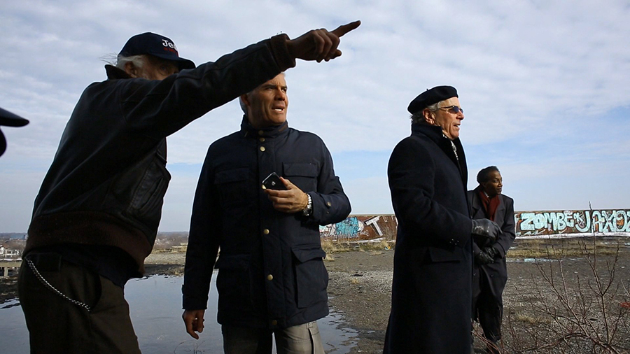 Fernando Palazuelo, center, new owner of the Packard Plant in Detroit, looks south as neighborhood resident Allan Hill points to the downtown skyline on Jan. 12.